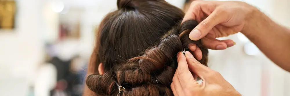 Stylist pinning hair into curls